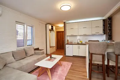 a living room with a couch and a table at AquaLux in Soko Banja