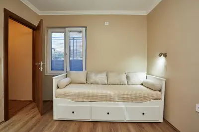 a white bed in a room with a window at AquaLux in Soko Banja