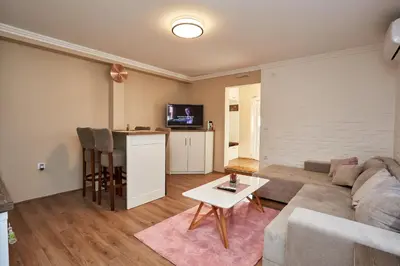 a living room with a couch and a table at AquaLux in Soko Banja