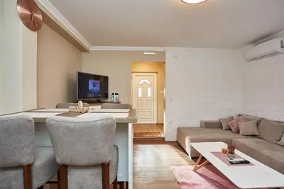 a living room with a couch and a table at AquaLux in Soko Banja
