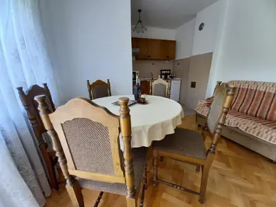 a dining room with a table and chairs and a couch at Smestaj Stanisavljevic in Soko Banja