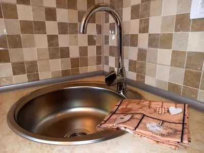 a metal sink with a faucet in a kitchen at Smestaj Stanisavljevic in Soko Banja
