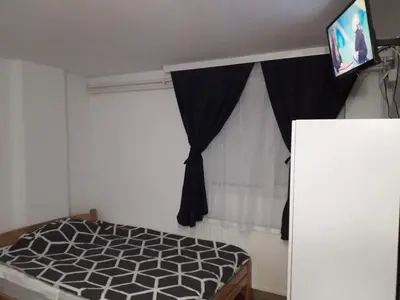 a bedroom with a bed with a tv on top at Smestaj Stanisavljevic in Soko Banja