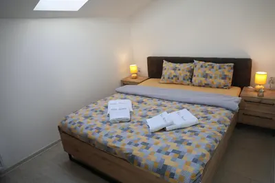 a bedroom with a bed with two boxes on it at Vila Nemir Zavojsko jezero in Pirot