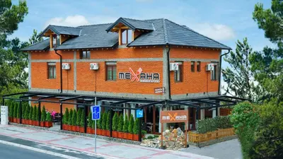 a large brick building on the side of a street at Mehana apartmani in Leskovac