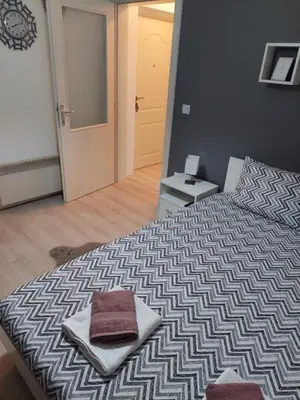 a bedroom with a bed with two towels on it at Vrnjacki apartmani in Vrnjačka Banja