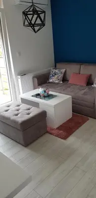 a living room with a couch and a coffee table at VIP APARTMAN 2020 in Vrnjačka Banja