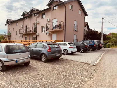 a group of cars parked in front of a building at VIP APARTMAN 2020 in Vrnjačka Banja