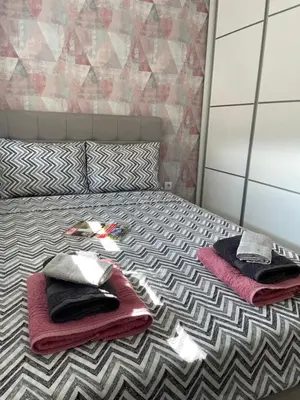 a bedroom with a bed with towels on it at VIP APARTMAN 2020 in Vrnjačka Banja