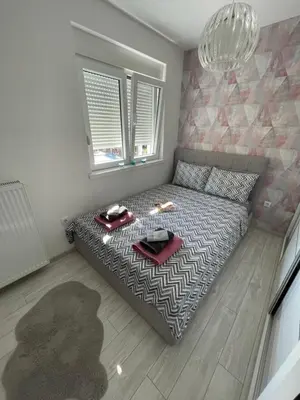 a bedroom with a bed with a tray of food on it at VIP APARTMAN 2020 in Vrnjačka Banja