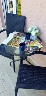a table with books and two blue cups on it at VIP APARTMAN 2020 in Vrnjačka Banja