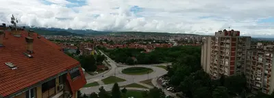 an aerial view of a city with buildings and trees at Bianco nero appartamento in Niš