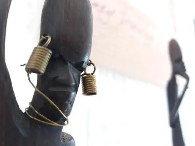 a statue of a person wearing a mask with earrings at Bianco nero appartamento in Niš