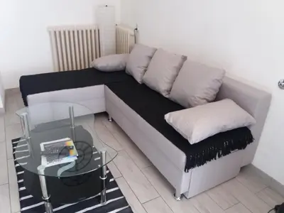 a couch in a room with a glass table at Bianco nero appartamento in Niš