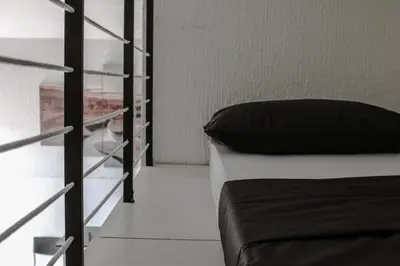 a bedroom with a bed and a glass shelf at Bianco nero appartamento in Niš