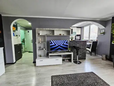 a living room with a tv on a shelf at Savić Apartment CENTER - PARKING FREE in Niš