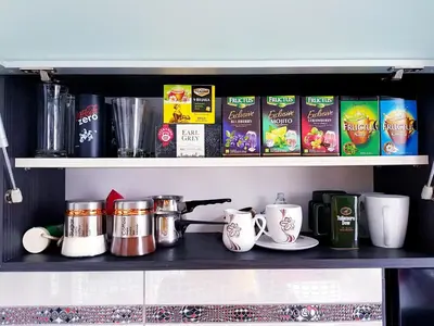 a shelf with cups and other items on it at Savić Apartment CENTER - PARKING FREE in Niš