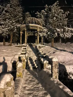 a gazebo in the snow in a park at Apartman Alibi in Boljevac