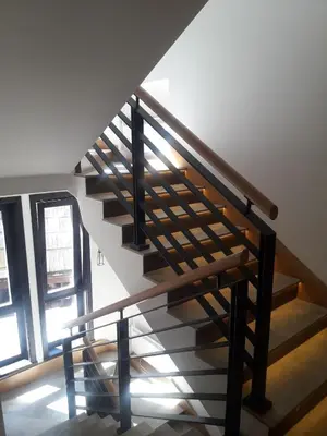 a staircase in a house with a wooden railing at KAMENA 6 in Kopaonik