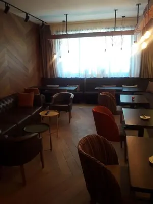 a restaurant with couches and tables and a window at KAMENA 6 in Kopaonik