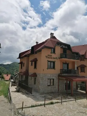 a large building with a sign on it at Vila Tiha noc in Kopaonik