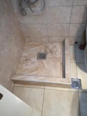 a shower with a drain in the floor of a bathroom at Vila Tiha noc in Kopaonik