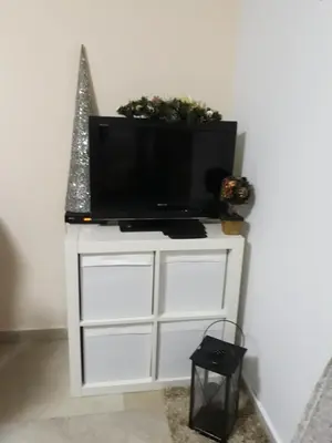 a flat screen tv on a white entertainment center at Vila Tiha noc in Kopaonik