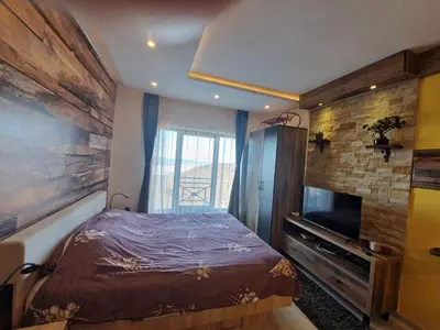 a small bedroom with a bed and a television at Milmari Pahulja in Kopaonik