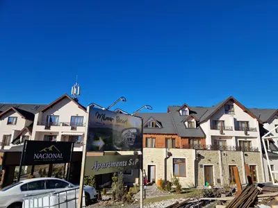 a sign in front of a row of houses at Milmari Pahulja in Kopaonik