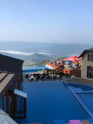 a large swimming pool with a view of the ocean at Milmari Pahulja in Kopaonik