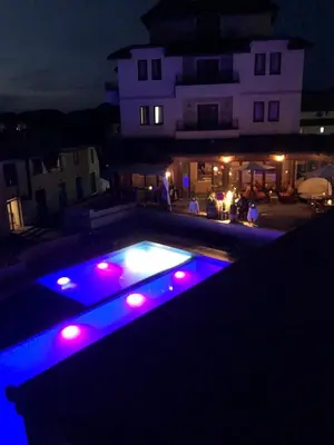 a swimming pool with blue and red lights at night at Milmari Pahulja in Kopaonik