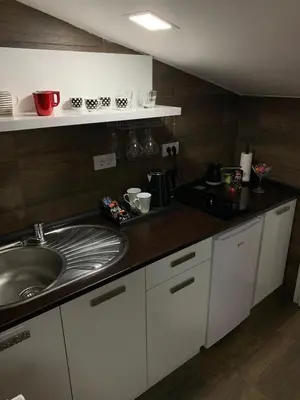 a kitchen with a sink and a counter top at MM Apartman in Kruševac