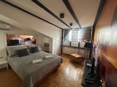a bedroom with a large bed in a room at MM Apartman in Kruševac
