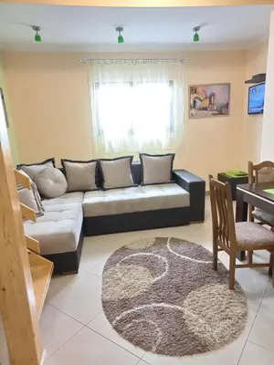 a living room with a couch and a table at Duplex lux in Kopaonik