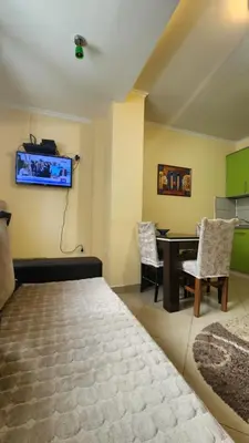 a bedroom with a bed and a desk and a tv at Duplex lux in Kopaonik