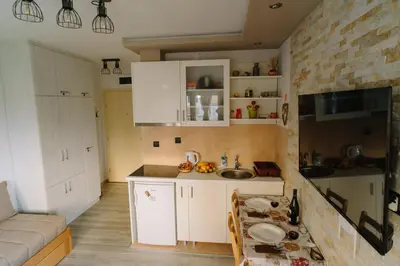 a small kitchen with white cabinets and a sink at Apartman Ristić in Vrnjačka Banja