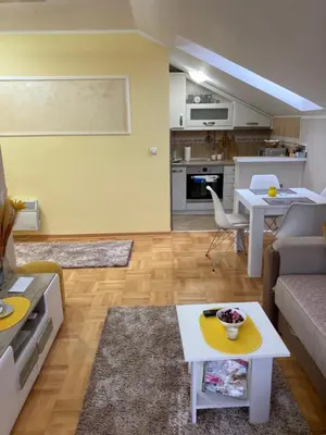 a living room with a couch and a table at Apartmani Grand LUX in Vrnjačka Banja