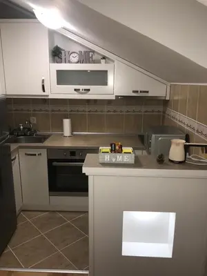 a kitchen with a sink and a stove top oven at Apartmani Grand LUX in Vrnjačka Banja