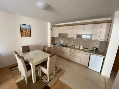 a kitchen and dining room with a table and chairs at Apartman Bozur in Vrnjačka Banja