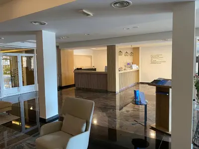 a lobby with a chair and a desk in a building at Apartman Bozur in Vrnjačka Banja