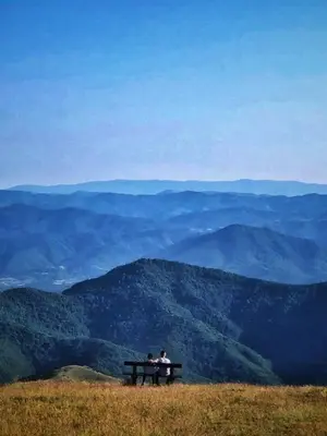 two people sitting on a bench on top of a mountain at Milmari M12 in Kopaonik