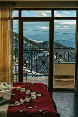 a room with a large window with a view of the mountains at Milmari M12 in Kopaonik