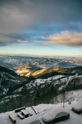 a snowy mountain with cars parked on a ski slope at Milmari M12 in Kopaonik
