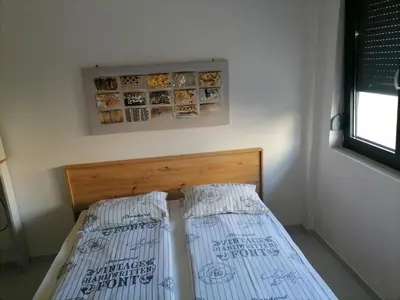 two beds sitting next to each other in a room at Stojanović Apartments in Niš