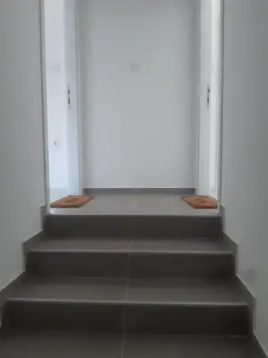 a stairway leading up to an open door at Stojanović Apartments in Niš