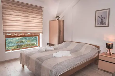 a bedroom with a large bed and a window at Cicmilovic P63, Milmari Resort, Kopaonik in Kopaonik