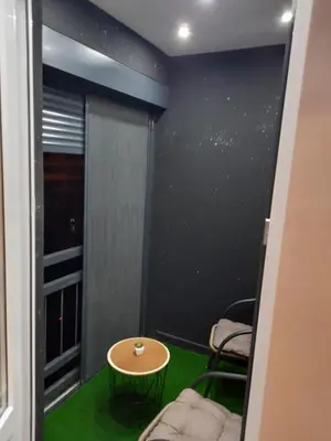 a room with a green floor and a table and chairs at Iva Lux apartman in Zaječar