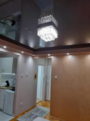 a kitchen with a chandelier in a room at Iva Lux apartman in Zaječar