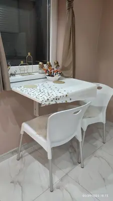 a white table with two white chairs and a sink at Iva Lux apartman in Zaječar