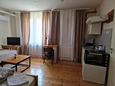a living room with a couch and a table at Ramonda Serbica- Peaceful Retreat in Sicevo Gorge in Niš